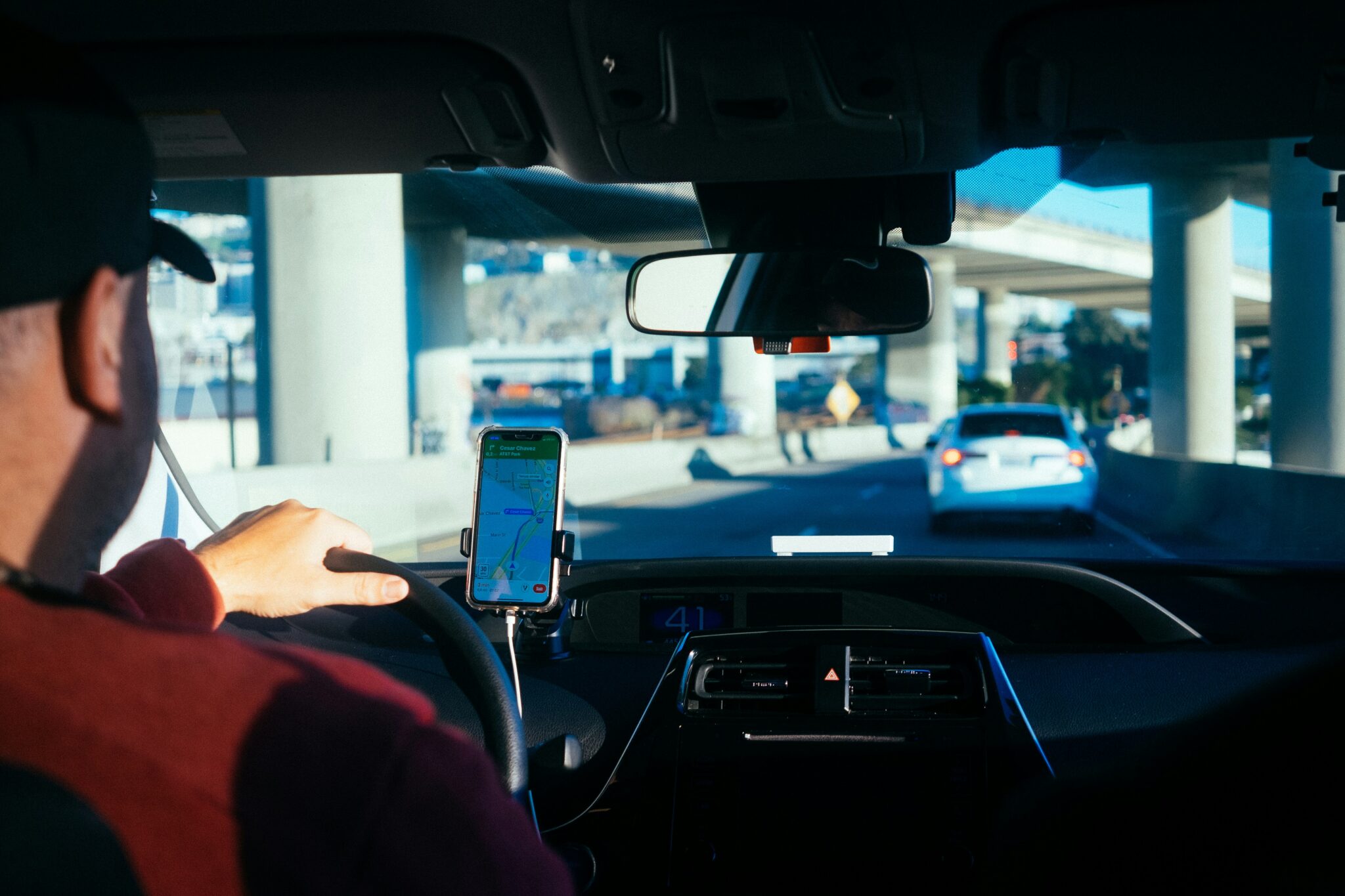 A passenger's view from the backseat of a rideshare vehicle