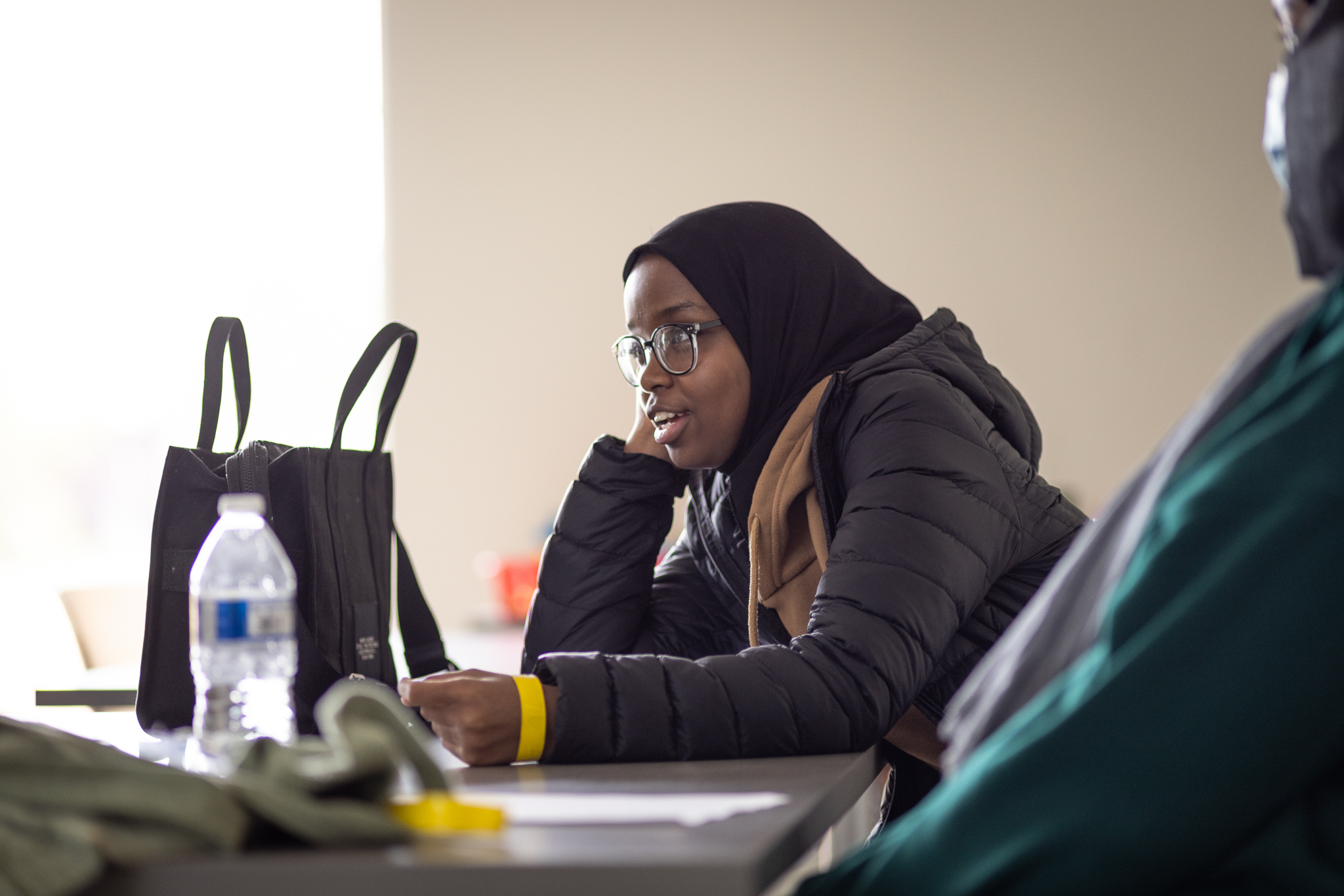 A young woman speaking from her desk in a Seattle Colleges classroom
