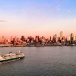 A ferry sailing towards downtown Seattle at sunset